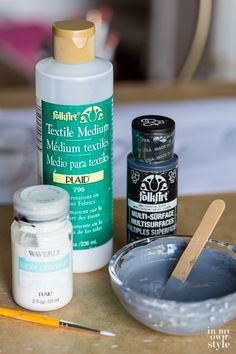 the supplies needed to make an acrylic painting project are displayed on a table