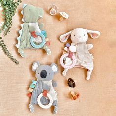 three stuffed animals are sitting next to each other on a table with buttons and beads