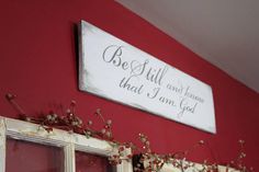 a sign that says be still and know that i am god hanging on the wall