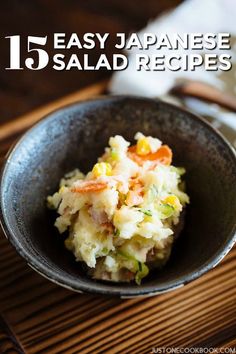 a bowl filled with food sitting on top of a wooden table next to a napkin