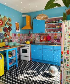 a kitchen with blue cabinets and black and white checkered flooring