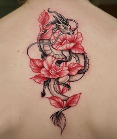 a woman's back with red flowers and a snake on it