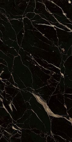 a black marble textured surface with white lines on the top and bottom, as well as dark colors