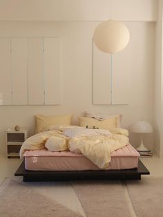 a bedroom with a large bed and white walls