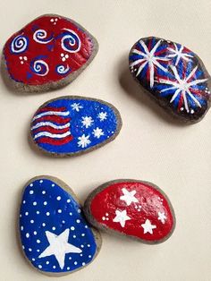 four painted rocks with stars and stripes on them