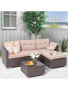 an outdoor sectional sofa set with pillows on the top and side tables in front of it