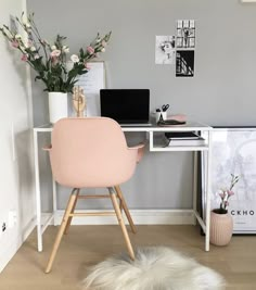 a white chair sitting in front of a computer desk