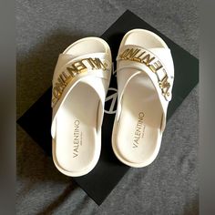 Brand New Original Packaging Women’s Sandals Elegant White Open Toe Slides, Designer Slides With Branded Insole For Beach, Designer Beach Slides With Branded Insole, Luxury White Open Heel Sandals, Luxury Synthetic Sandals For The Beach, Luxury Synthetic Beach Sandals, Designer Flat Slides For Beach, White Flat Heel Sandals With Removable Insole, Designer Synthetic Sandals For Beach