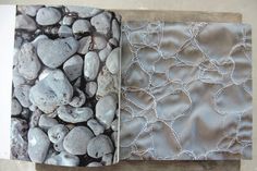 an open book with rocks and lace on it