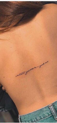 the back of a woman's neck with an inscription on it that says, you are