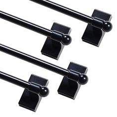 three black door handles with square knobs on each one and two balls in the middle