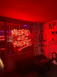 a room with red lights and posters on the wall