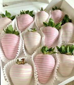 a box filled with lots of pink strawberries