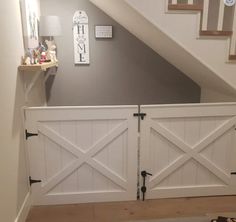 the inside of a house with two white doors and some pictures on the wall behind them