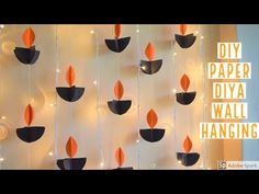 diy paper diya wall hangings with orange and black leaves on the side