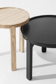 two black and wooden tables sitting next to each other