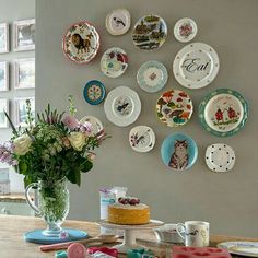 a table topped with lots of plates and flowers