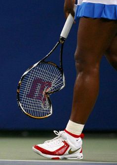 a tennis player is holding her racket on the court