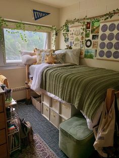 a bedroom with a bed and lots of storage boxes on the bottom floor, next to a window