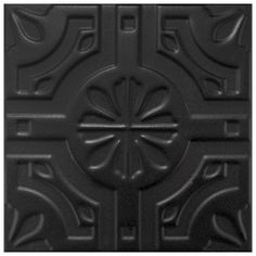 a close up view of a black tile with an intricate design on the center and sides