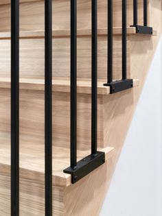 a wooden stair case with metal railings