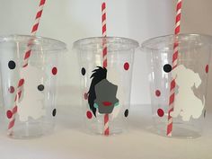 three plastic cups with red and white striped straws on them, one has a silhouette of a woman