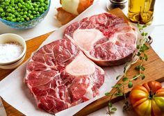 raw meat on cutting board with vegetables and seasoning