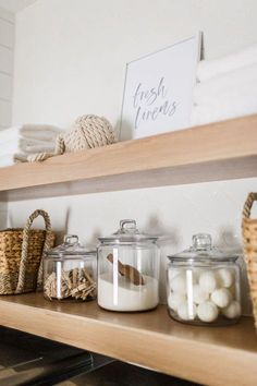 the shelves are filled with glass jars and baskets