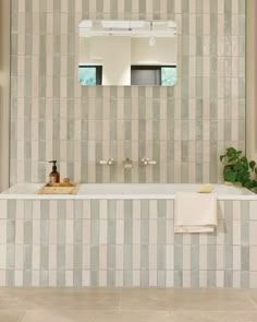 a bathroom with a sink, mirror and bathtub in the middle of the room