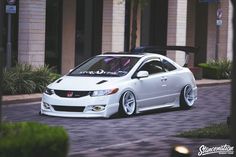 a white car parked in front of a building