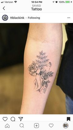 a woman's arm with flowers on it and the words tattoo written in black ink