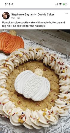 a cookie cake decorated with white frosting and cookies