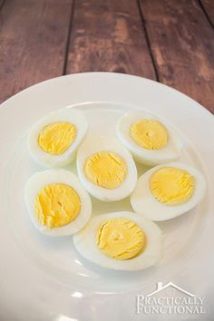 four hard boiled eggs on a white plate