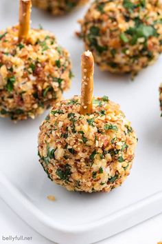 mini cheese ball appetizers on a white plate with toothpicks in them