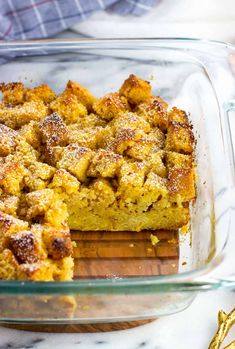 a casserole dish filled with bread and topped with powdered sugar