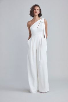 a woman wearing white jumpsuits with one shoulder