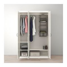 an open white wardrobe with clothes hanging on the wall and shelves in front of it