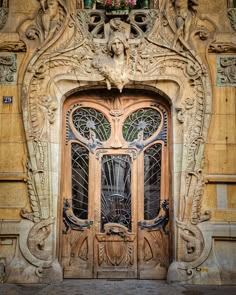 an ornate wooden door in front of a building