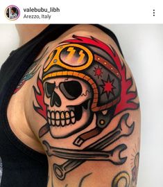 a man with a skull and helmet tattoo on his arm