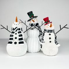 three snowmen are standing next to each other