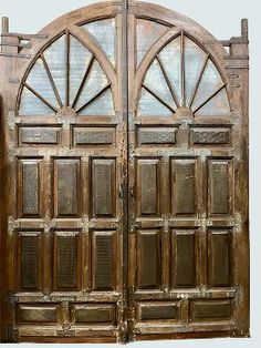 an old wooden door with arched glass panels