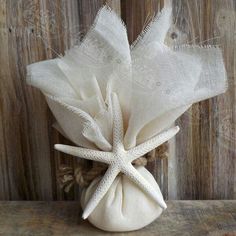 a white bag filled with starfish on top of a wooden table