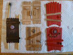 several pieces of wood are laid out on a towel with buttons and magnets attached to them