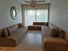 a living room filled with furniture and a chandelier