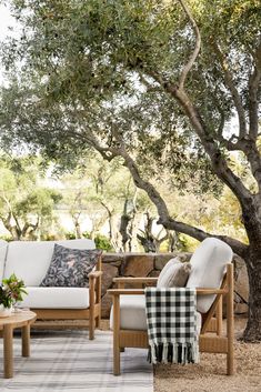 an outdoor living area with furniture and trees