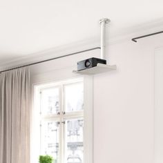 an overhead camera mounted on the side of a wall