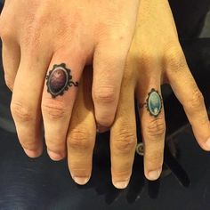 two people with rings on their fingers, one has a ring and the other has an oval