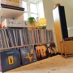 there are many records on the shelf in this room and one is full of them