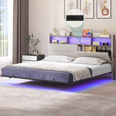 a bedroom with a bed, nightstands and pictures on the wall above it is lit up by blue lights