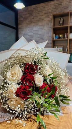 a bouquet of flowers sitting on top of a wooden table